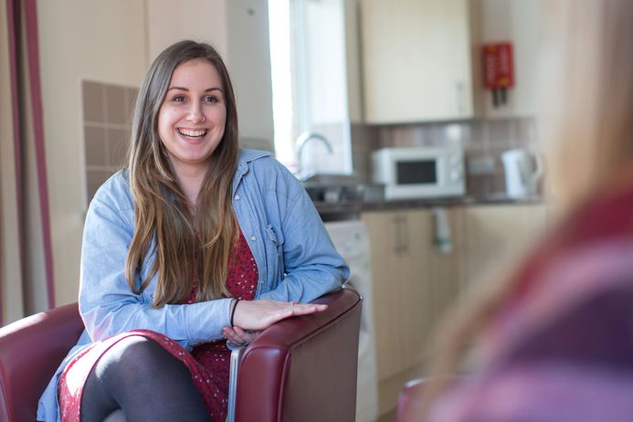 Student sitting on chair smiling