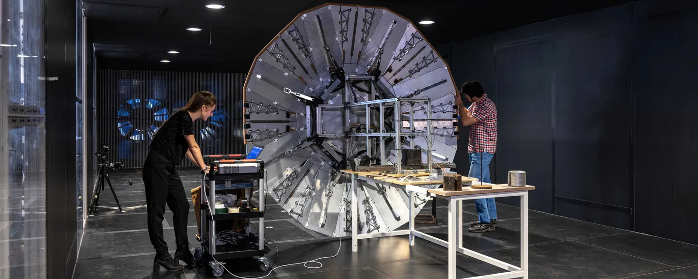 Two Aeronautics researchers working on a rigid deployable heat shield to protect space vehicles from the intense heat of entry into Mars’ atmosphere