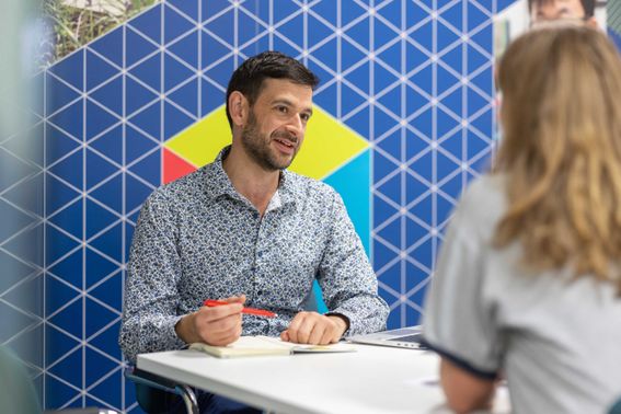 A student talking to a member of the Student Financial support team
