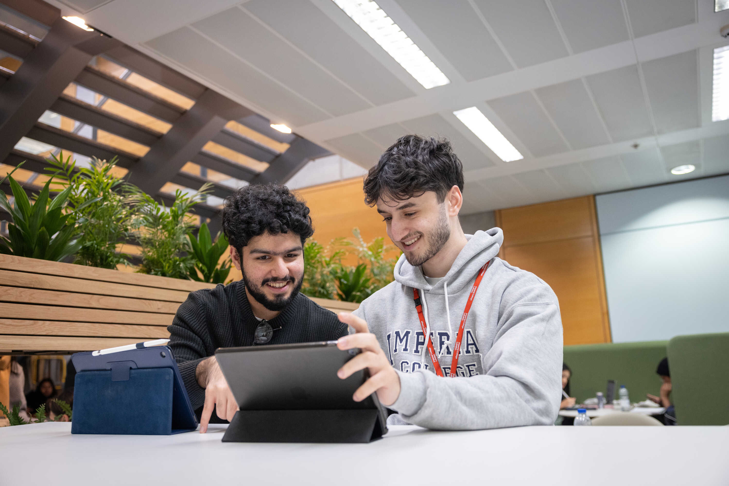 Students smiling looking at tablet