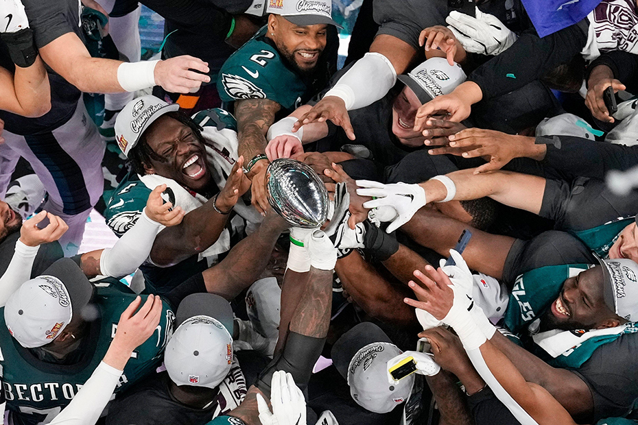 Philadelphia Eagles players celebrate with the Vince Lombardi Trophy after the Eagles won the NFL Super Bowl 59 football game against the Kansas City Chiefs in New Orleans.