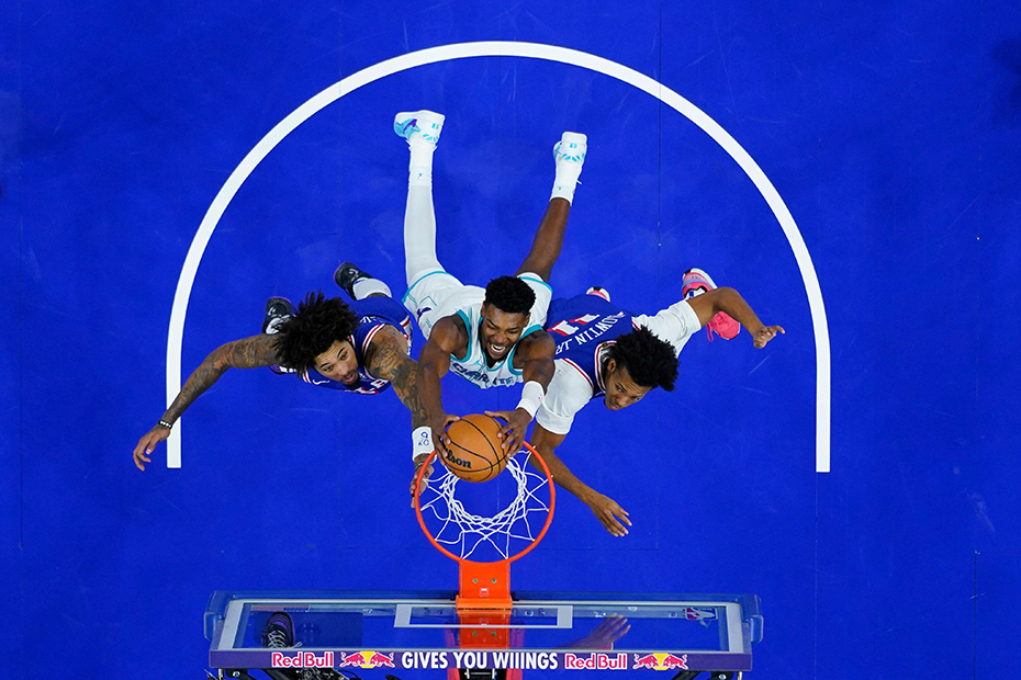 Charlotte Hornets' Brandon Miller dunks between Philadelphia 76ers' Kelly Oubre Jr and Jeff Dowtin Jr during the second half of an NBA basketball in Philadelphia. 