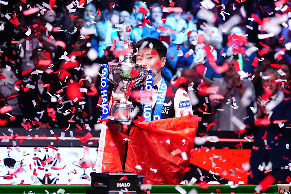 Zhao Xintong kisses the trophy after the final match against Mark Williams (not pictured) following day seventeen of the Halo World Snooker Championship at the Crucible Theatre, Sheffield.