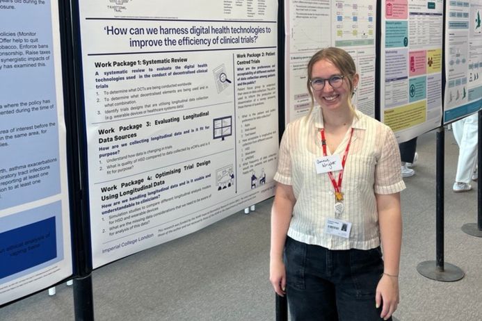 A student standing in front of a board