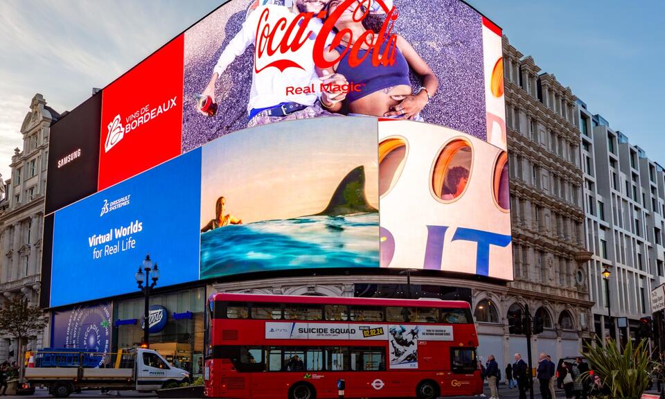 Photo of central London with brand logos behind red bus