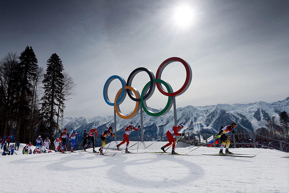 Eventual winner Switzerland's Dario Cologna lies second as the field passes the Olympic rings in the Men's 15km + 15km Skiathlon during the 2014 Sochi Olympic Games in Sochi, Russia