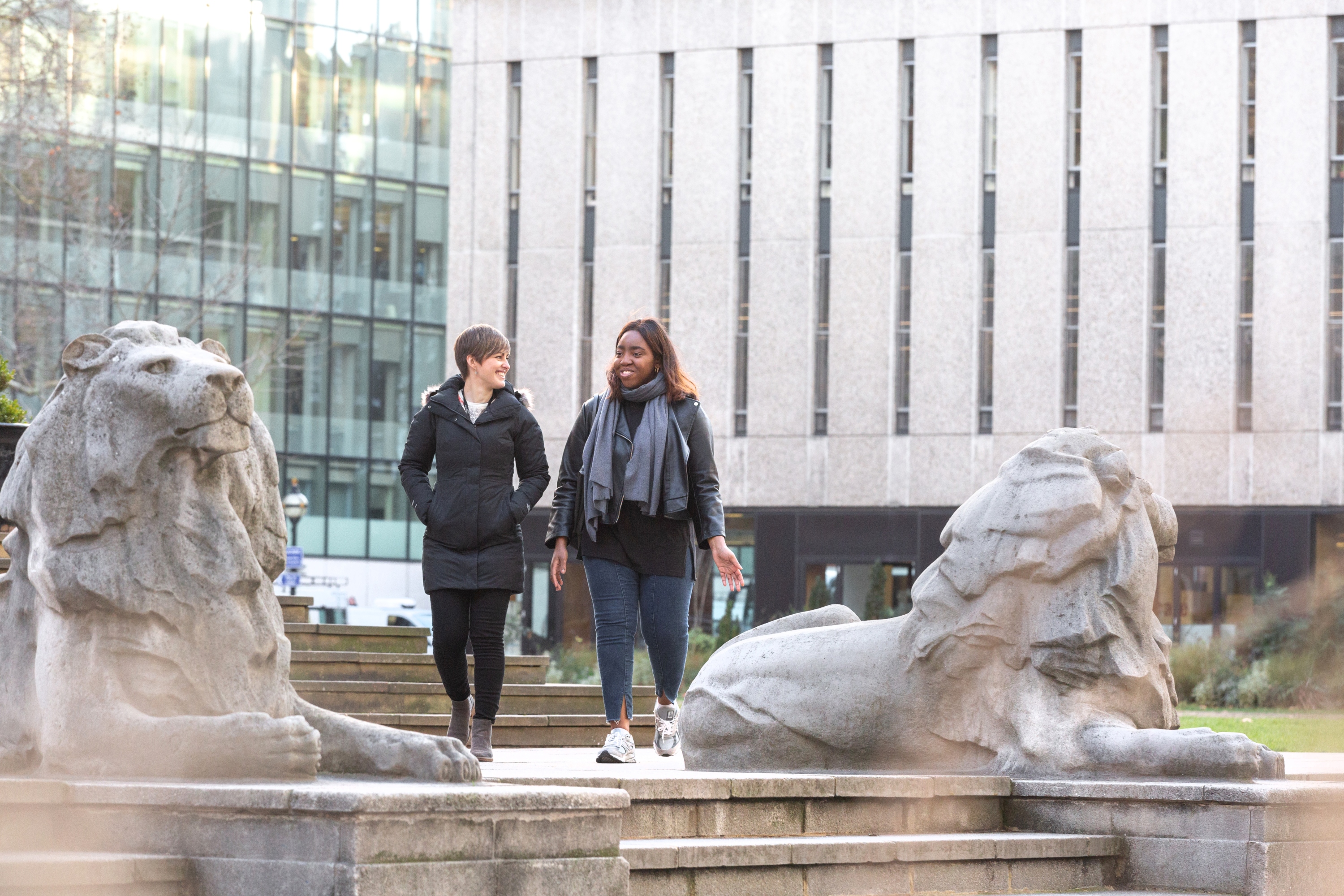 Two women walking on campus