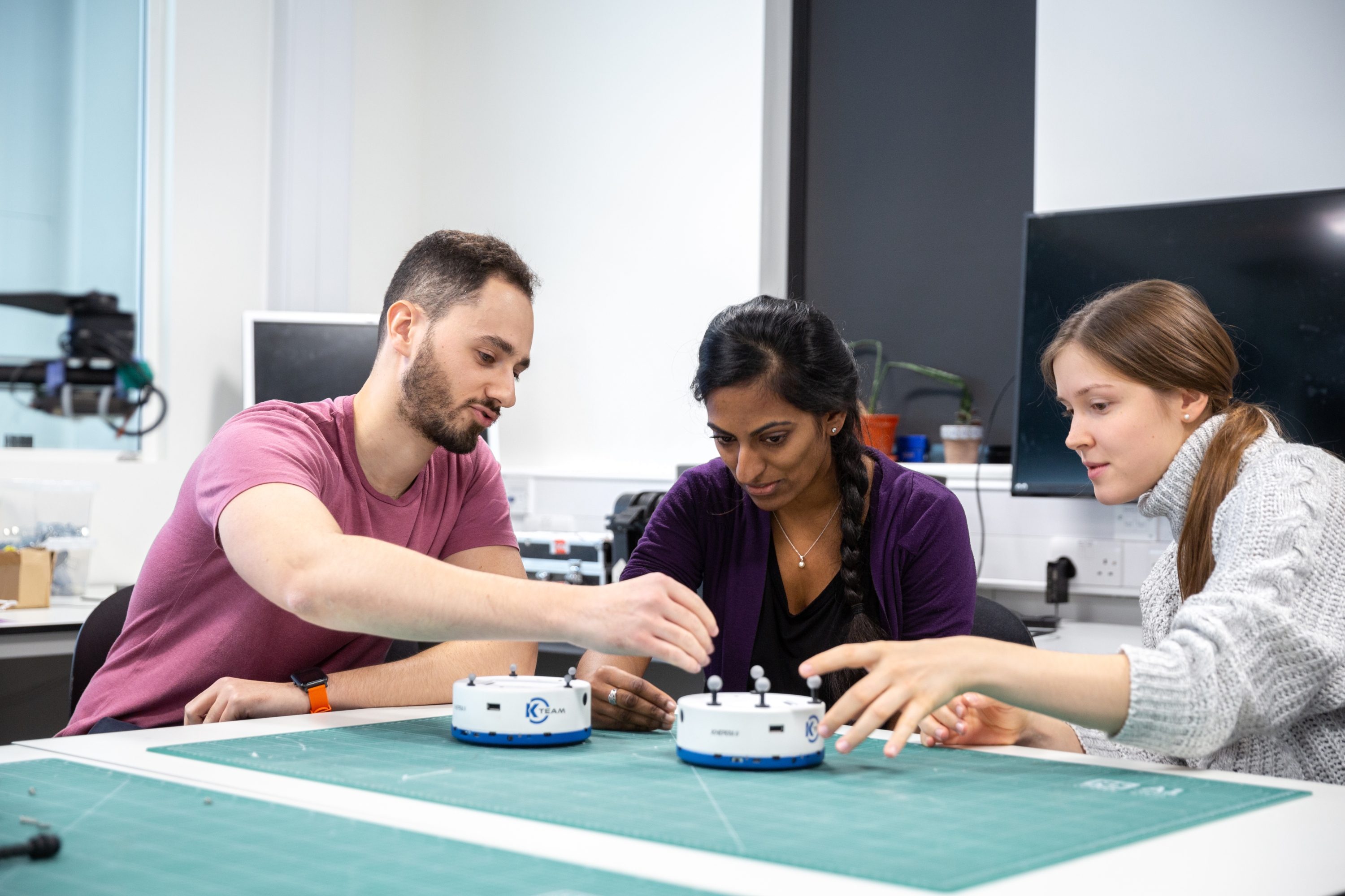 Three students working on a project