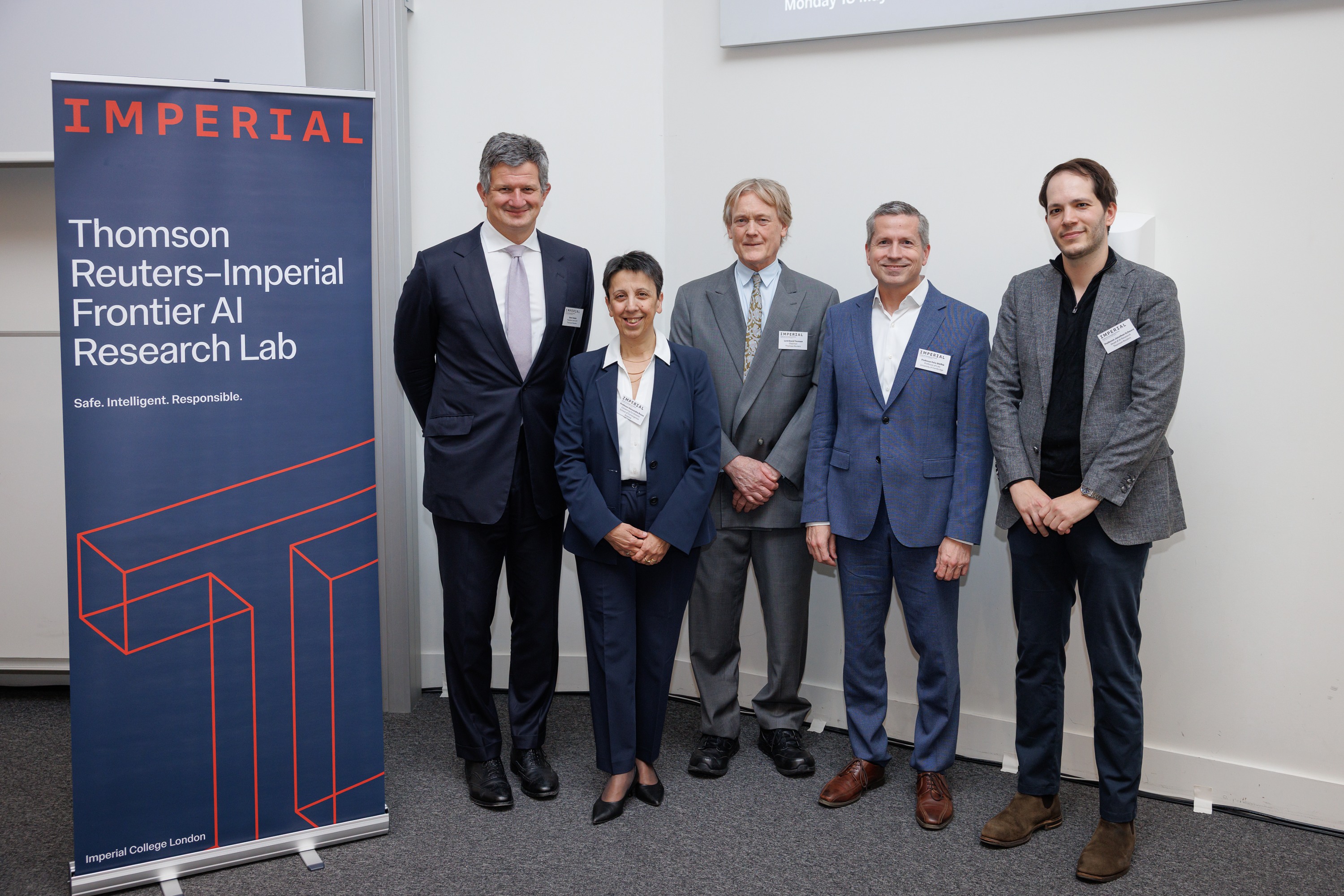 From L-R: Steve Hasker, Alessandra Russo, Lord Thomson, Felix Steffek and Jonathan Schwarz stand together next to a pull up banner with details of the new Frontier AI Research Lab
