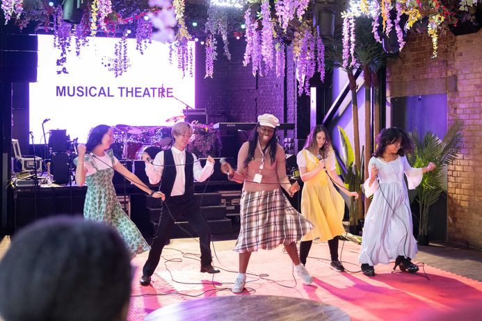 Students performing musical theatre in the student union